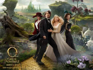 Moview poster for Oz the Great andd Powerful, with the cast standing on a wooded path and the emerald city in the background
